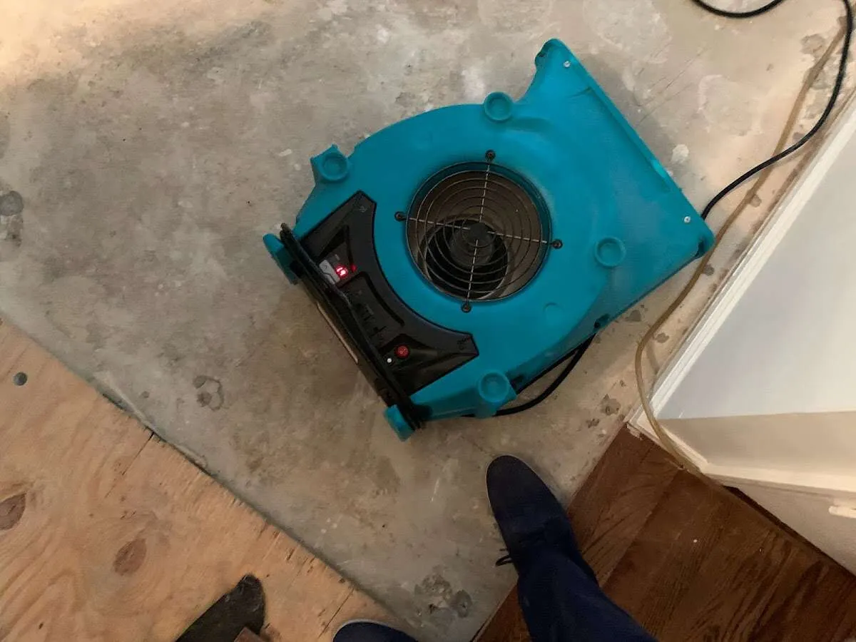 Air mover drying subfloor during Commercial Water Damage Restoration in Cottonwood Heights
